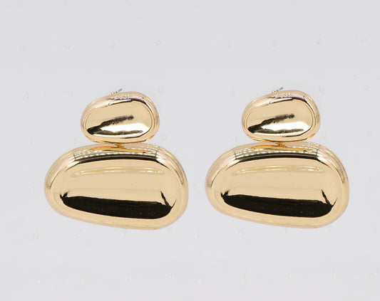 Pair of gold earrings on a light gray background