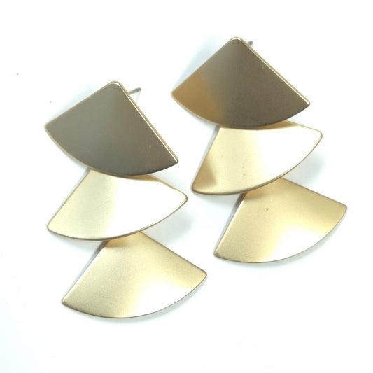 Pair of gold earrings with layered fan-shaped design on a white background