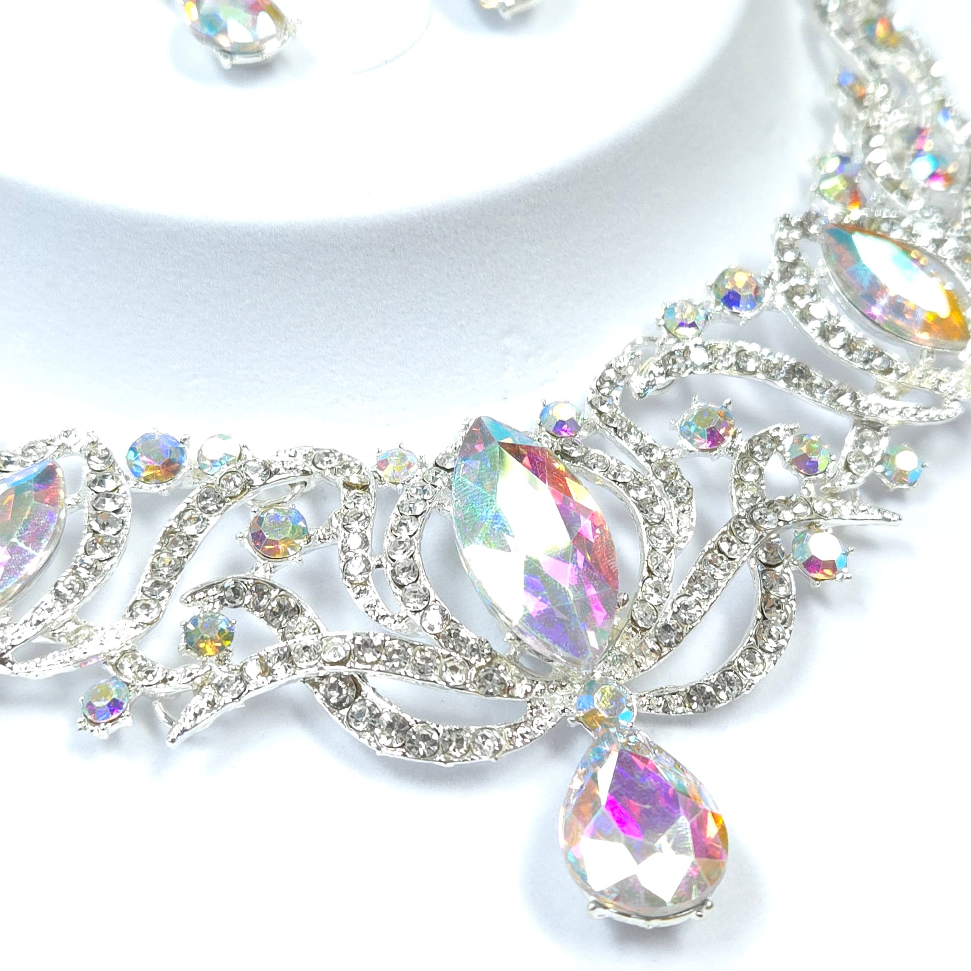 Close-up of a decorative brooch with multicolored gemstones on a white background