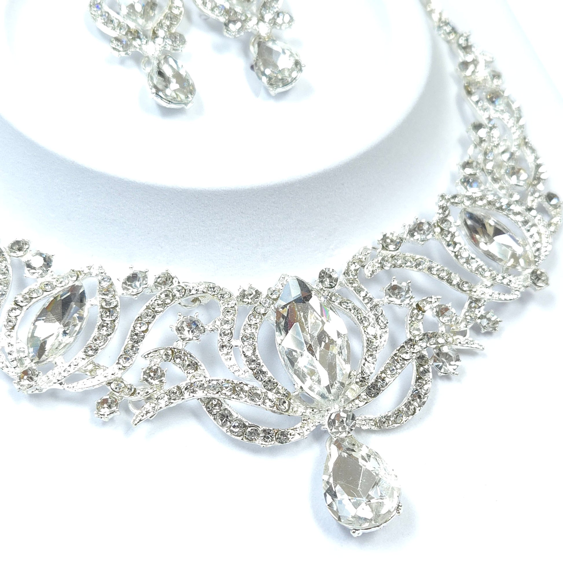 Silver bracelet with clear gemstones on a white background