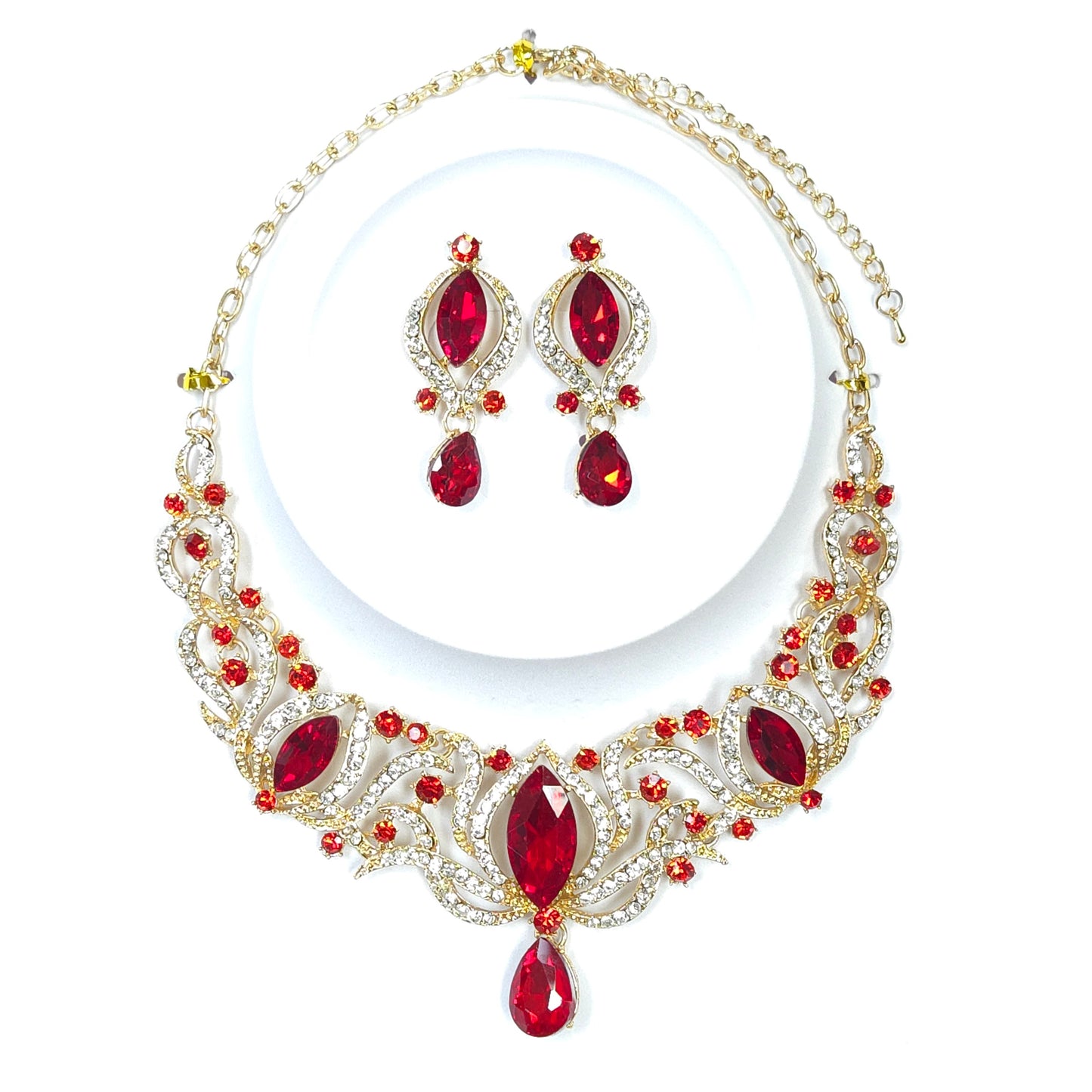 Jewelry set with red gemstones and gold accents on a white background