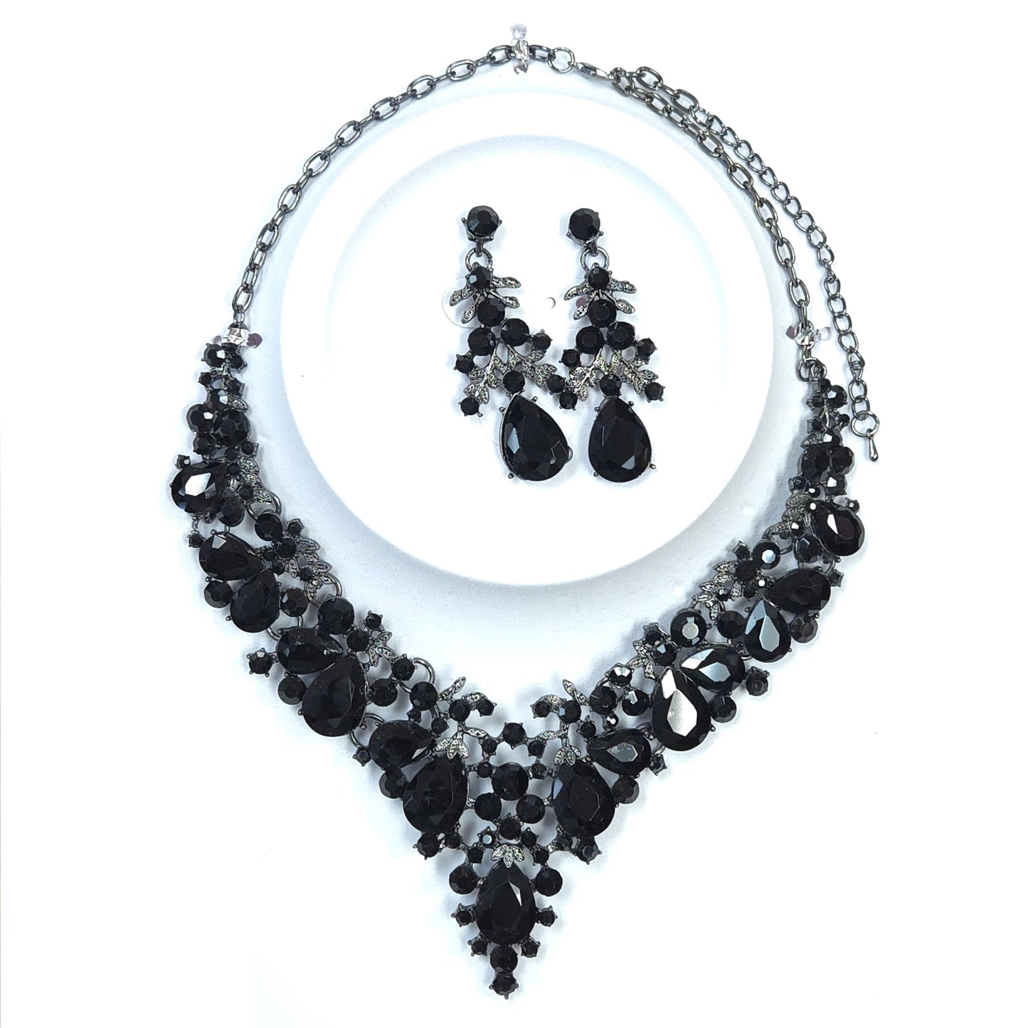 Black and silver jewelry set with necklace and earrings on a white background