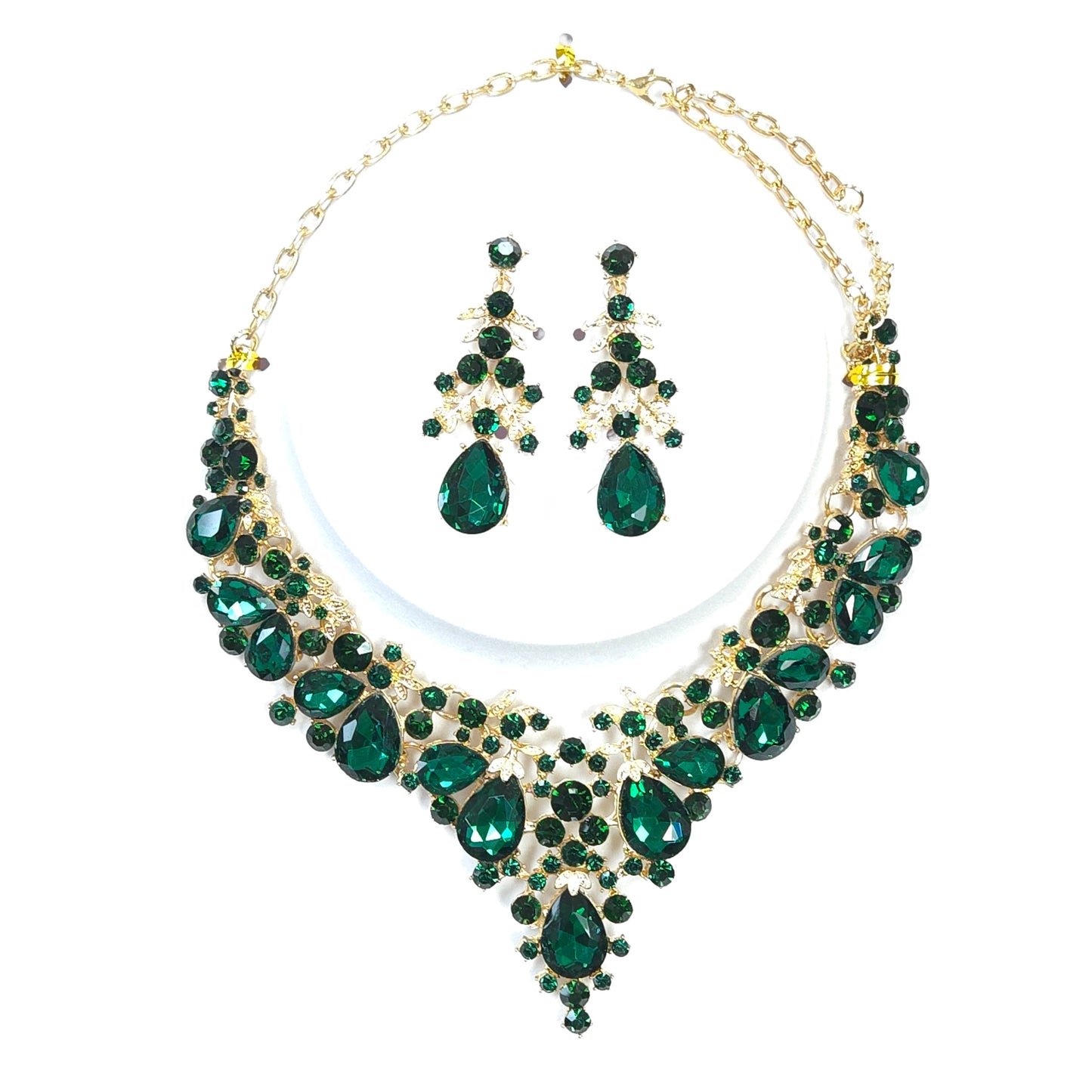 Green gemstone necklace and earrings set on a white background