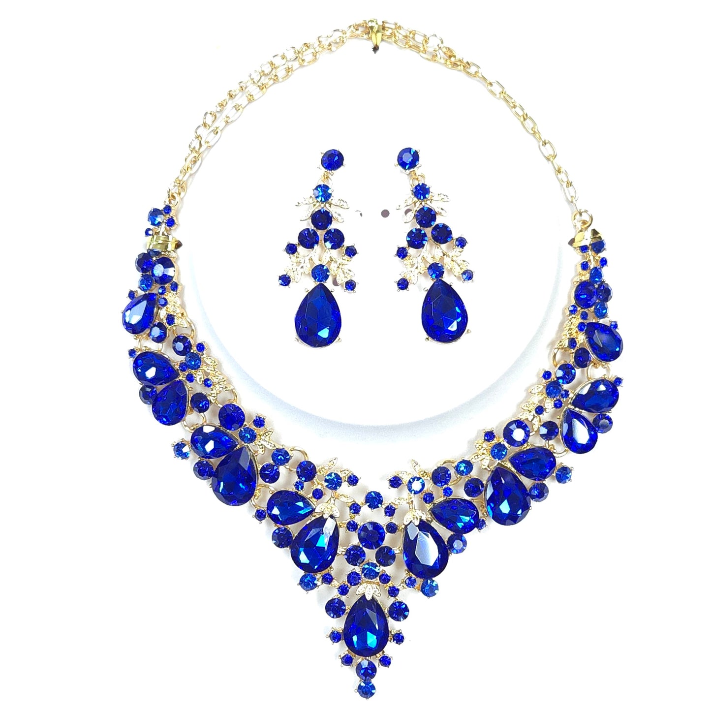 Jewelry set with blue teardrop-shaped stones on a white background