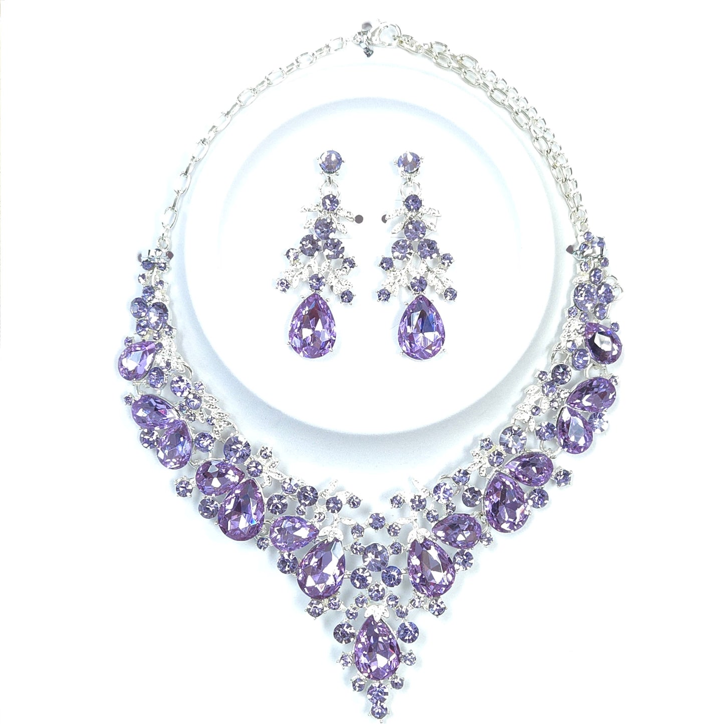 Purple jewelry set with necklace and earrings on a white background