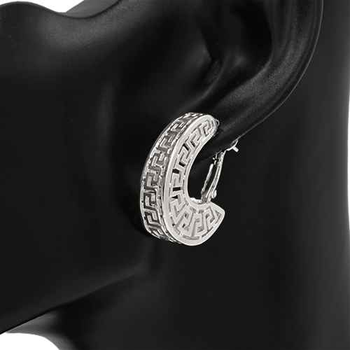 Greek pattern hoop earrings featuring geometric cutout detailing and a bold crescent silhouette.