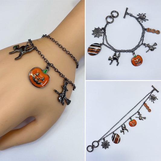 Halloween charm bracelet featuring pumpkin, witch, spiderweb, ghost, and striped enamel charms on a chain link bracelet.