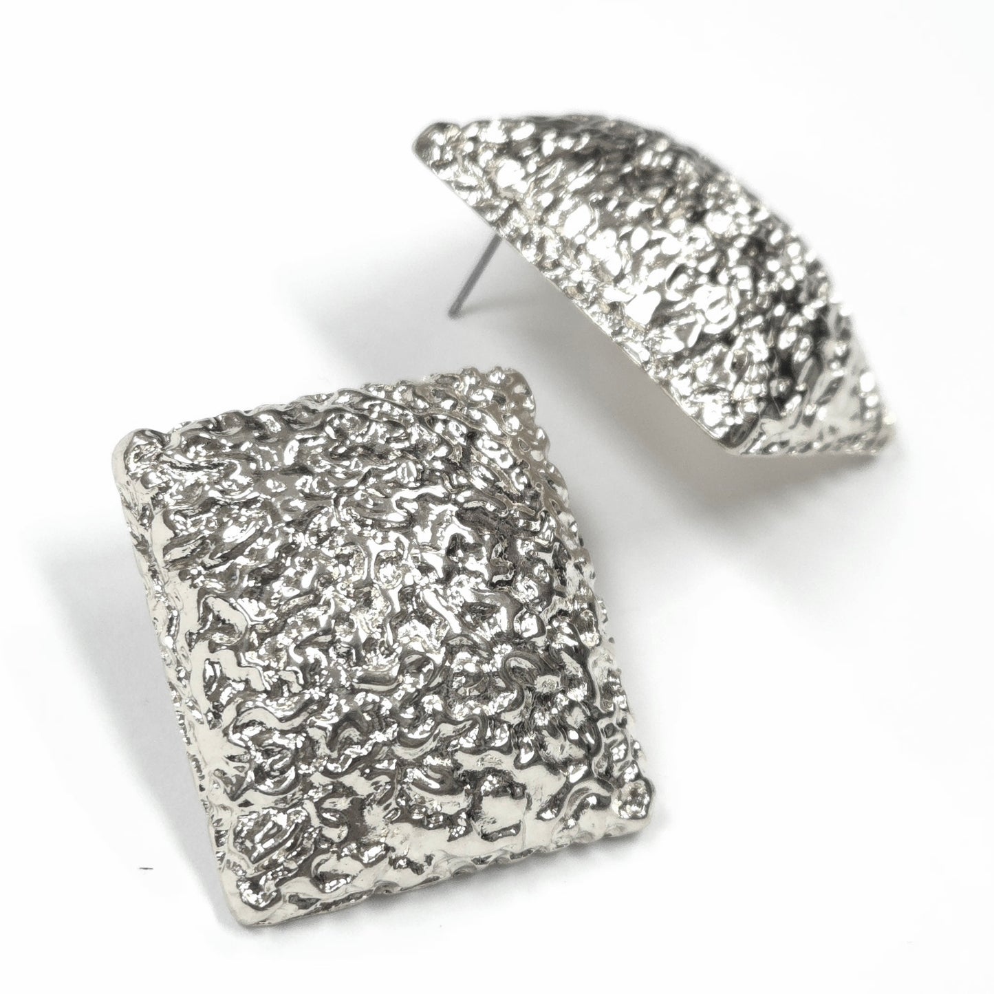 Silver textured square earrings on a white background