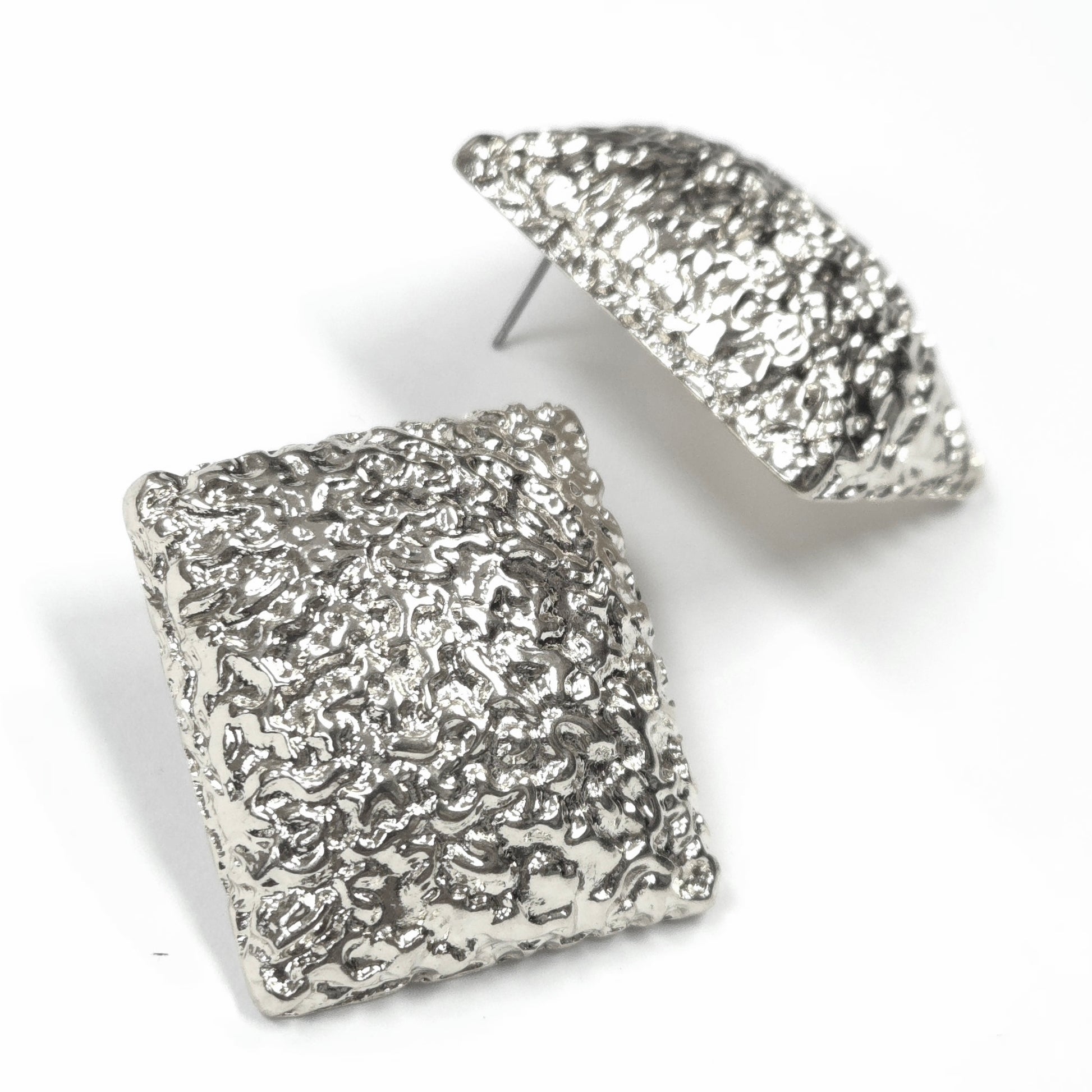 Silver textured square earrings on a white background