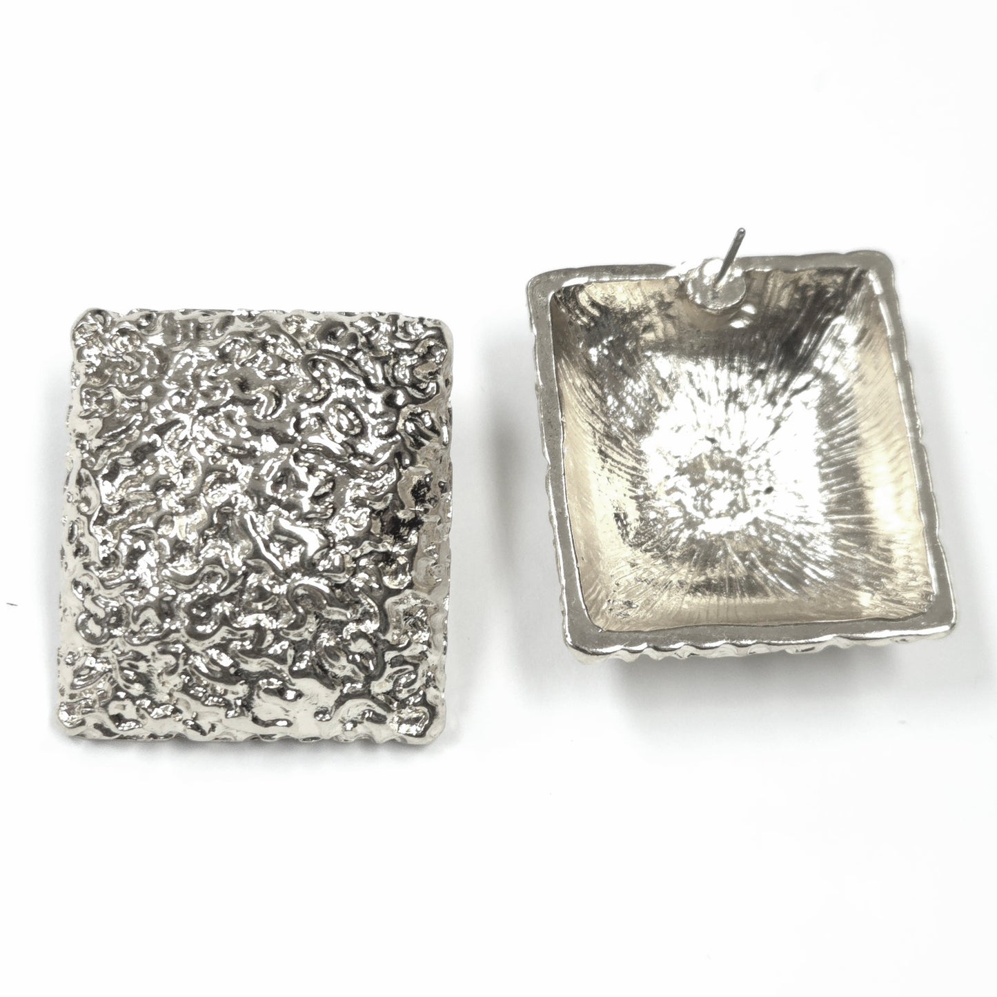 Two silver square pendants with textured surfaces on a white background