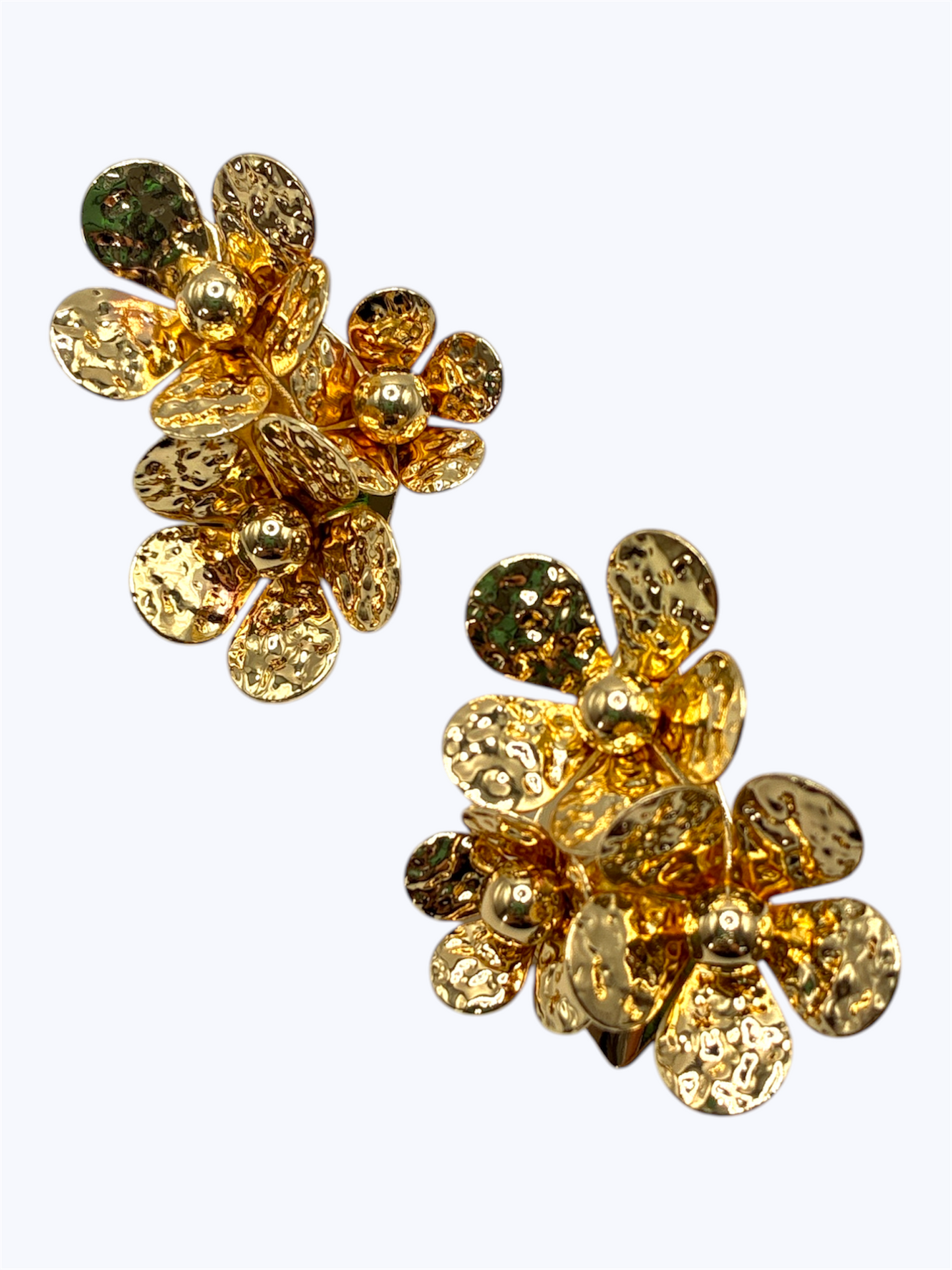 Pair of gold floral earrings on a white background