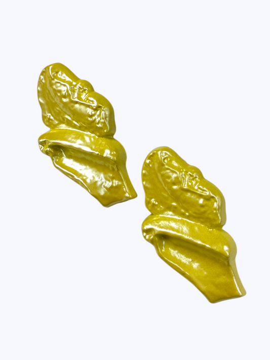 Glossy abstract statement earrings with sculpted yellow resin design for a playful contemporary boutique-inspired look.