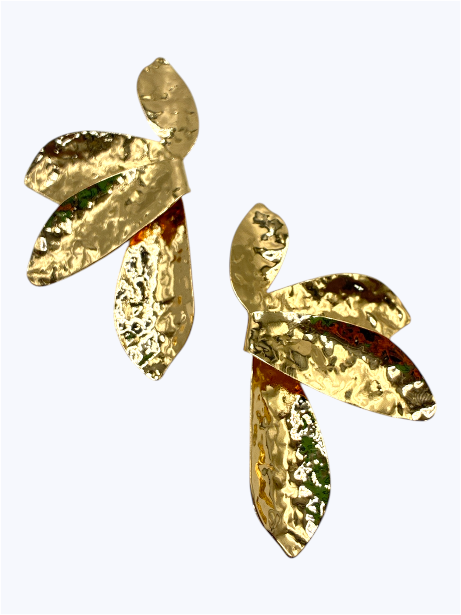 Hammered metal drop earrings with layered abstract leaf shapes and textured organic finish.