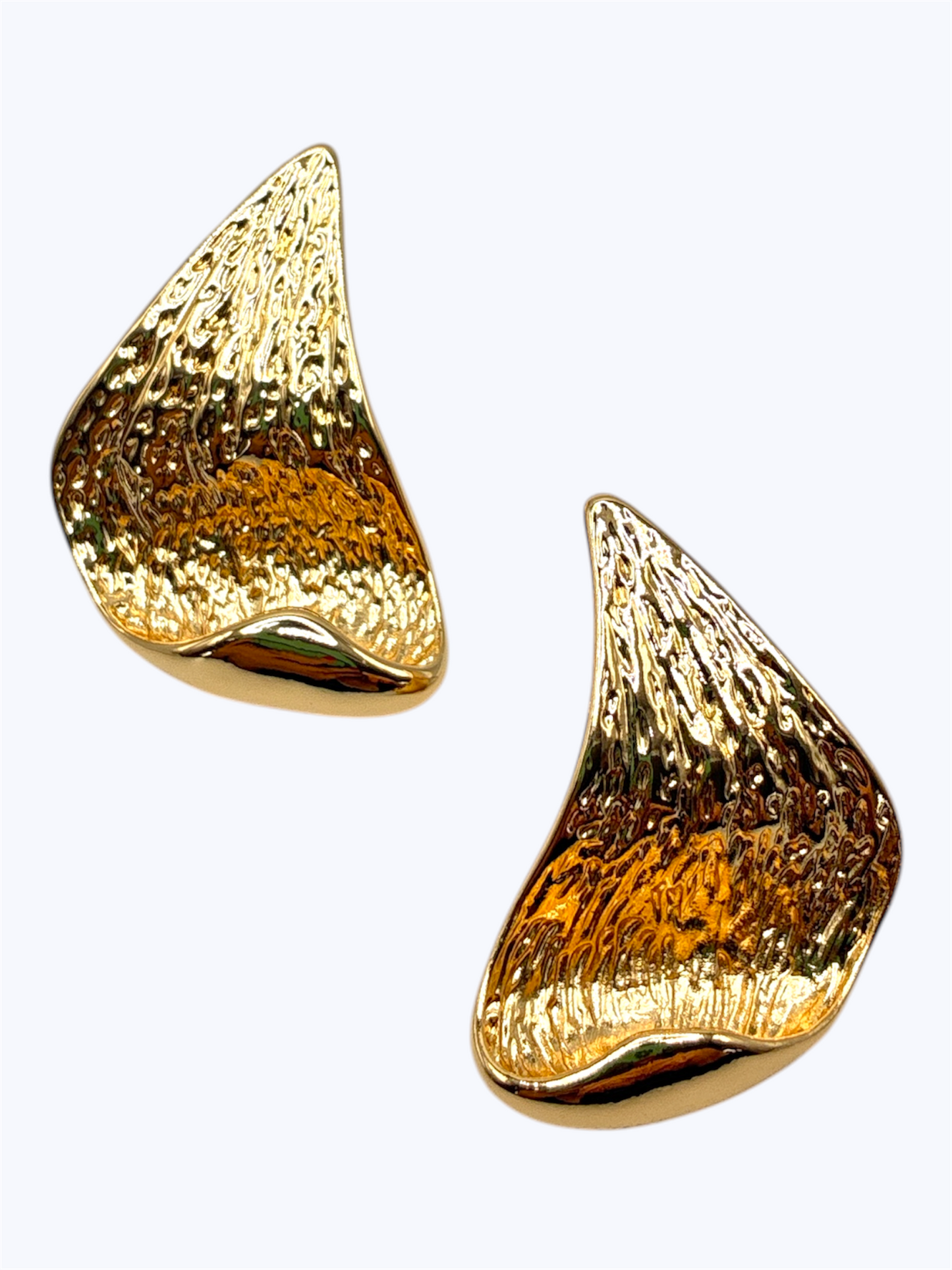 Sculpted textured stud earrings with abstract curved shell-inspired organic design.