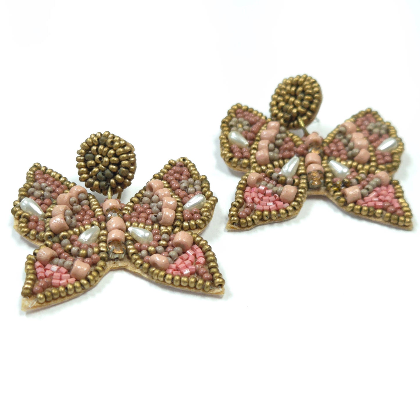 Two decorative bow-shaped pins with pink and gold beads on a white background
