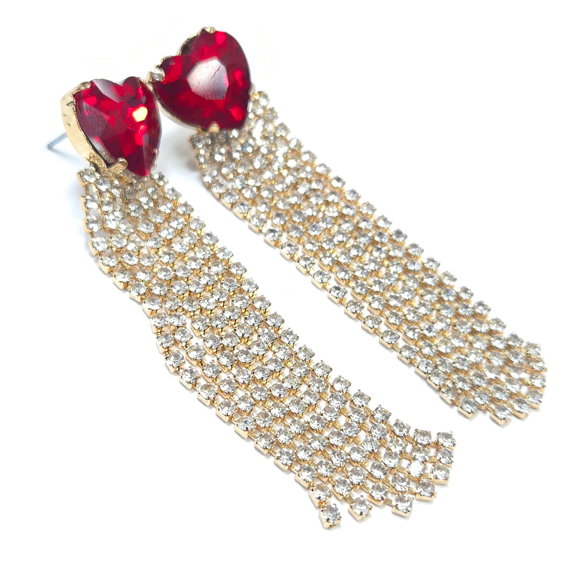 Heart-shaped red gemstone earrings with gold and clear rhinestone chains on a white background