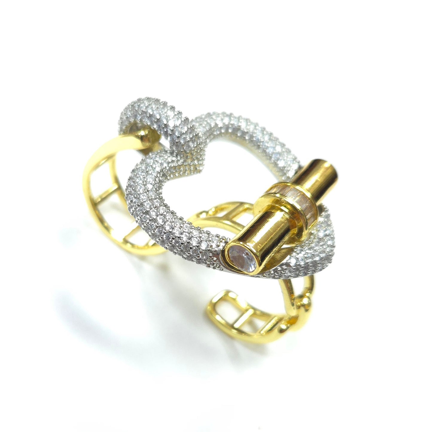 Gold and silver ring with intricate design on a white background