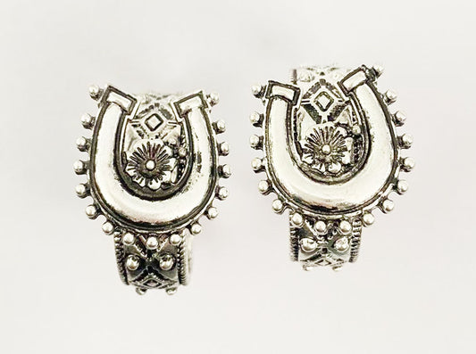 Pair of silver horseshoe-shaped earrings on a white background