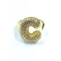 Gold ring with embedded stones on a white background