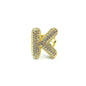 Gold letter 'K' ring with gemstones on a white background
