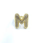 Gold ring with letter 'M' design on a white background