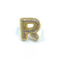 Gold letter 'R' charm with gemstones on a white background