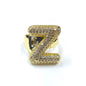Gold ring with a z-shaped design on a white background