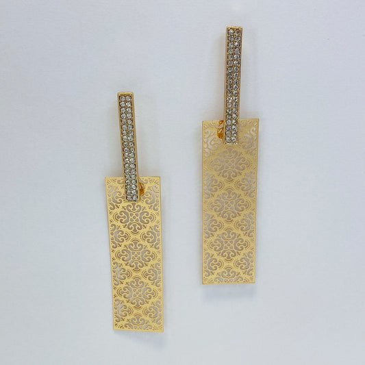 A pair of gold earrings on a white background
