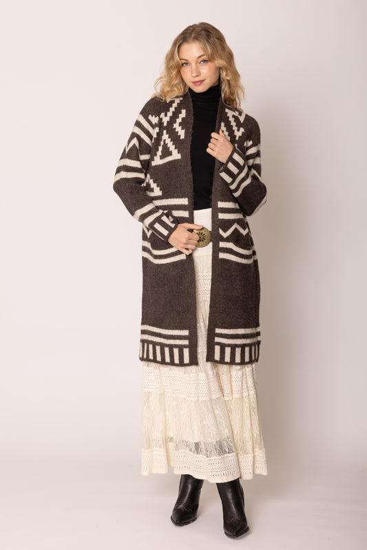 A girl wearing a brown poncho.