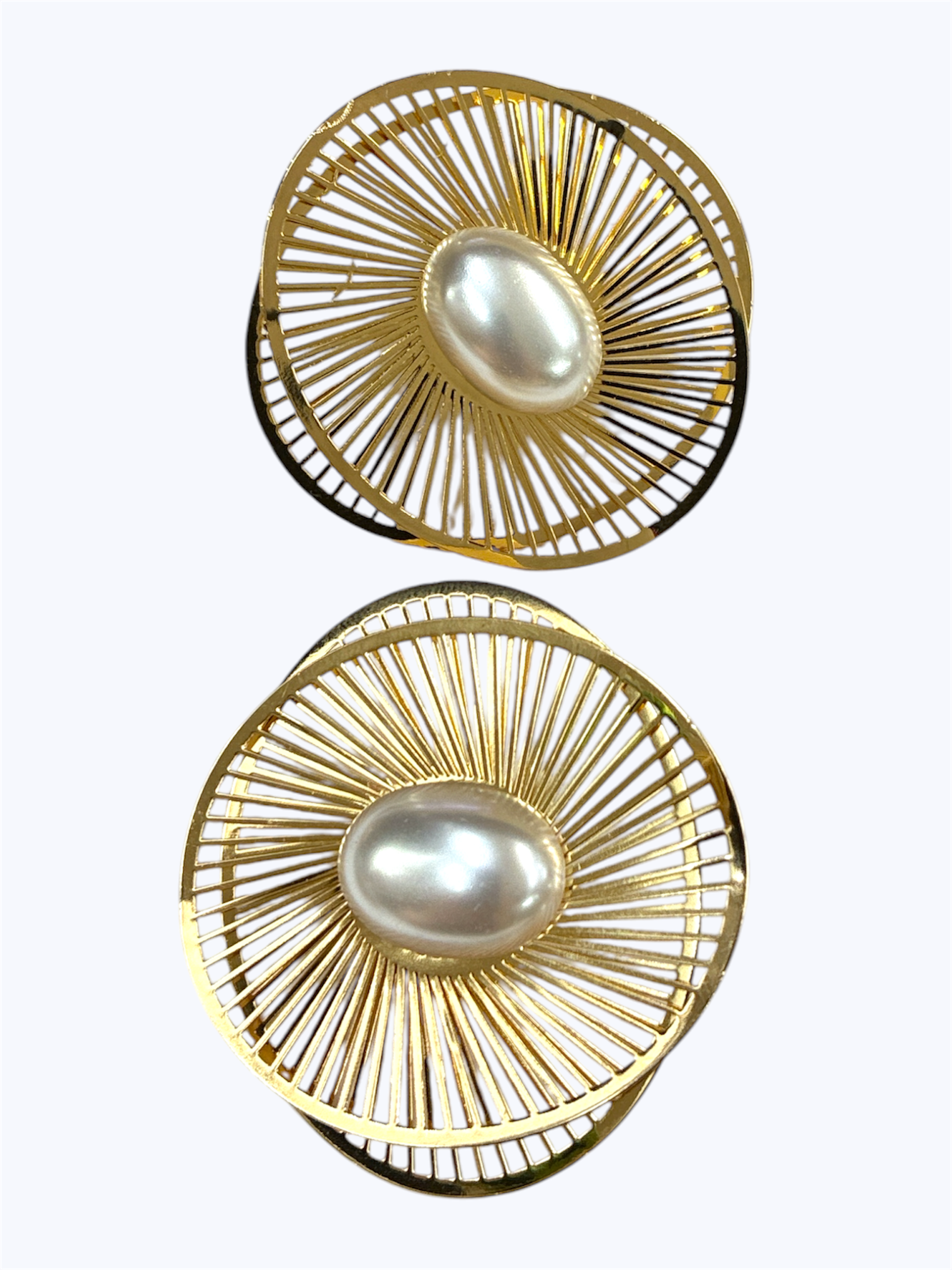 Round openwork stud earrings with radiant sunburst design and oval pearl center detail.