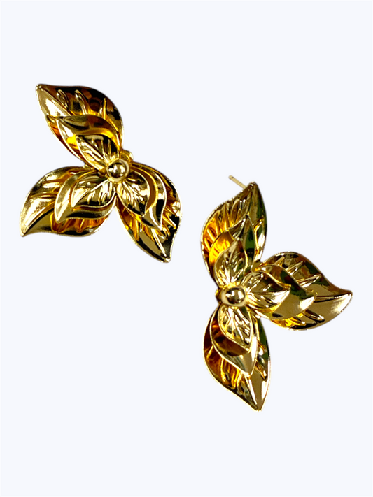 Pair of gold butterfly-shaped earrings on a white background