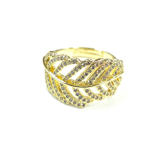 Gold ring with diamond accents on a white background