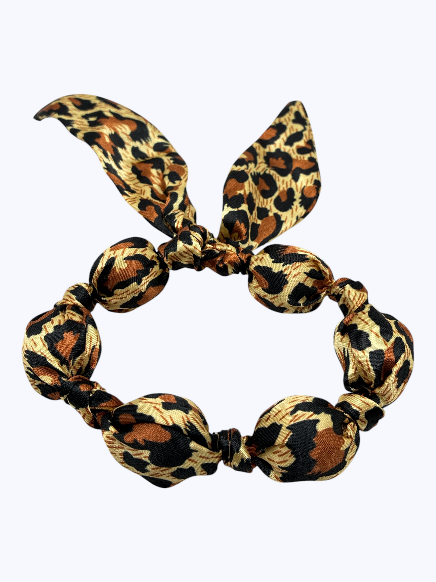 Leopard print hair scrunchie with bunny ears on a white background