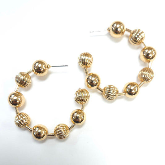 Pair of gold hoop earrings on a white background