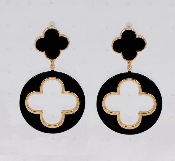 Black and gold earrings with clover design on a light gray background