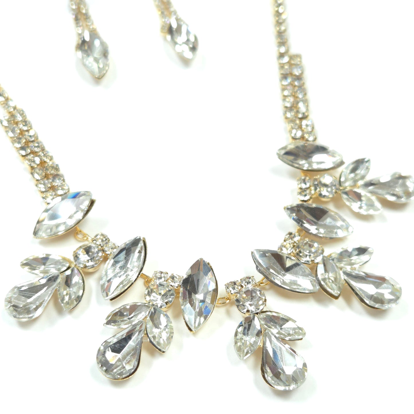 Close-up of a decorative hairpiece with crystal-like stones on a white background