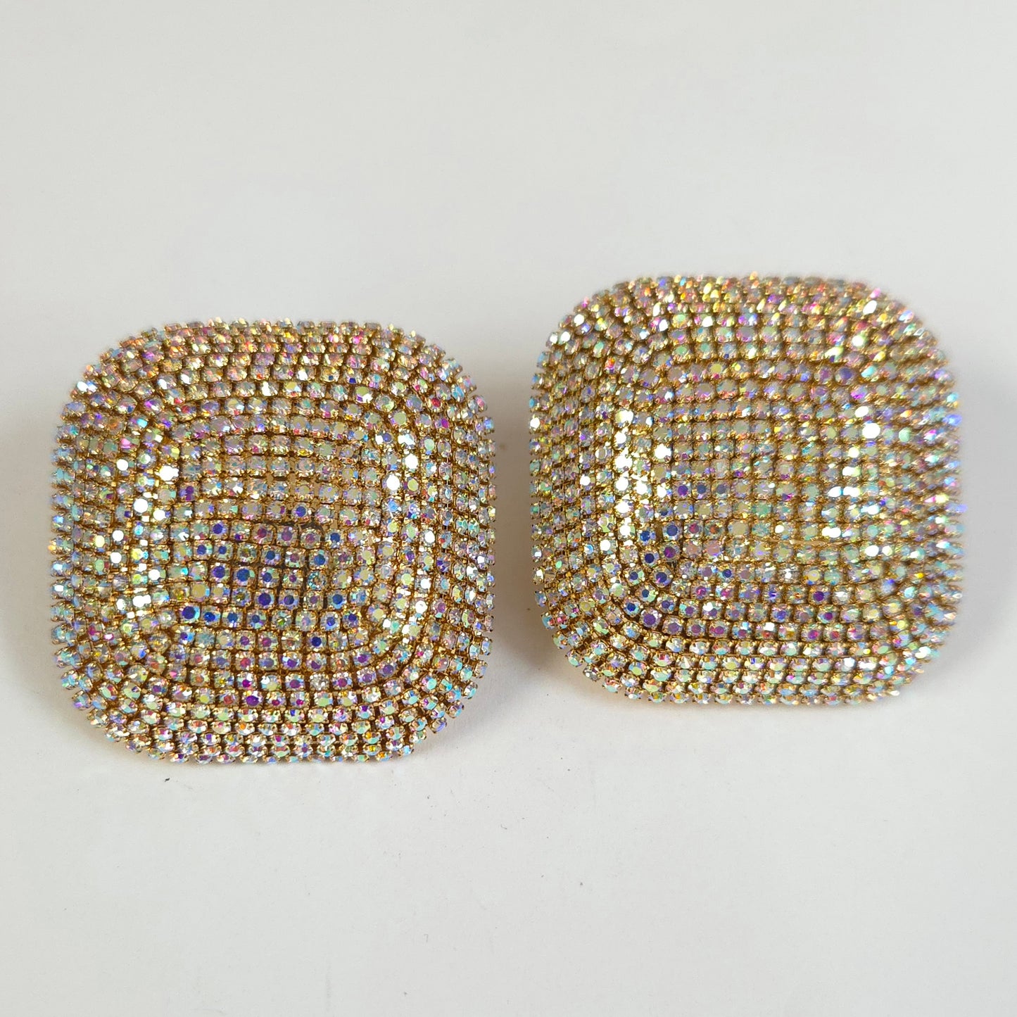 Pair of square-shaped earrings with rhinestone embellishments on a white background