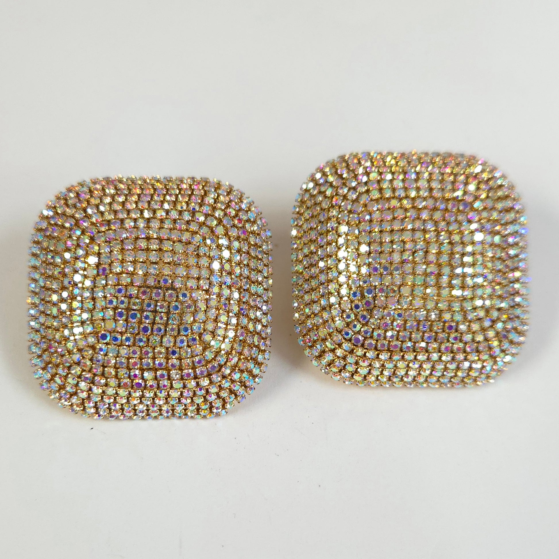 Pair of square-shaped earrings with rhinestone embellishments on a white background