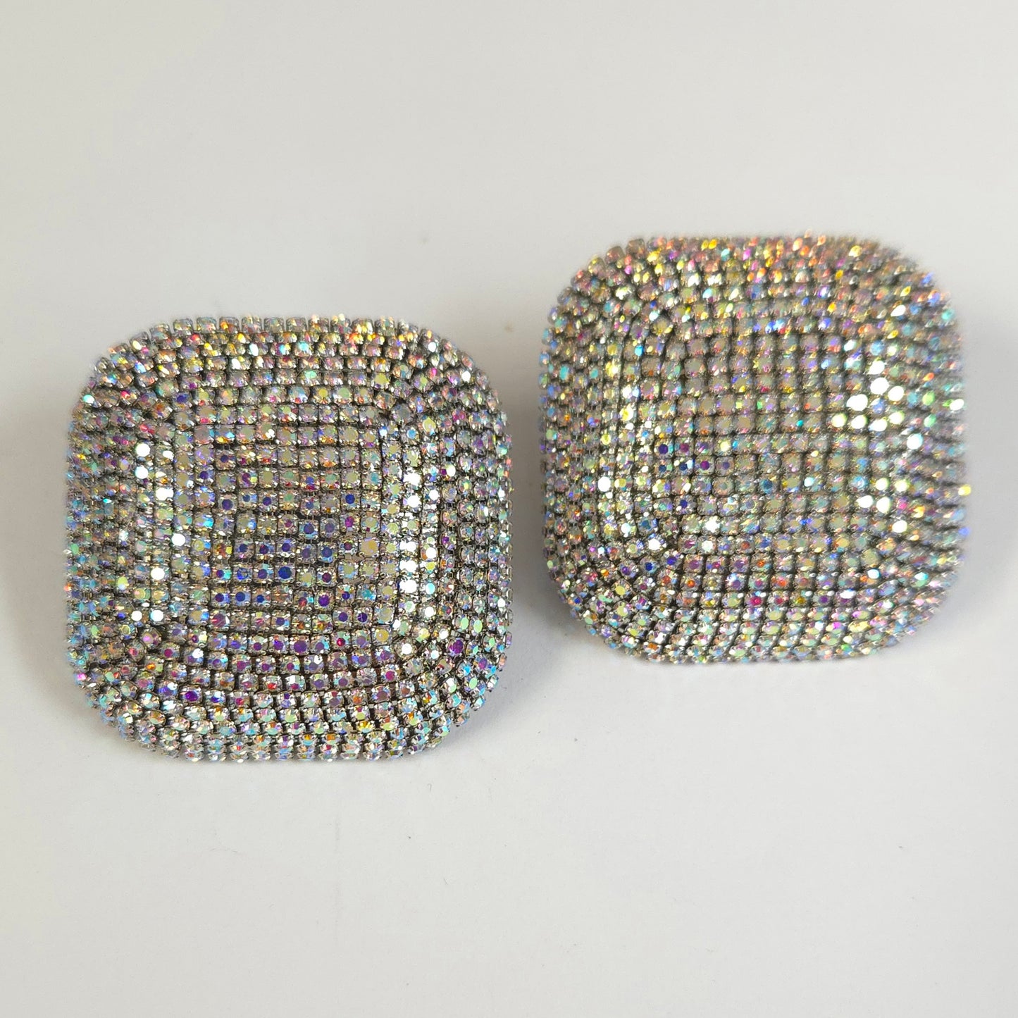 Pair of square rhinestone earrings on a light gray background