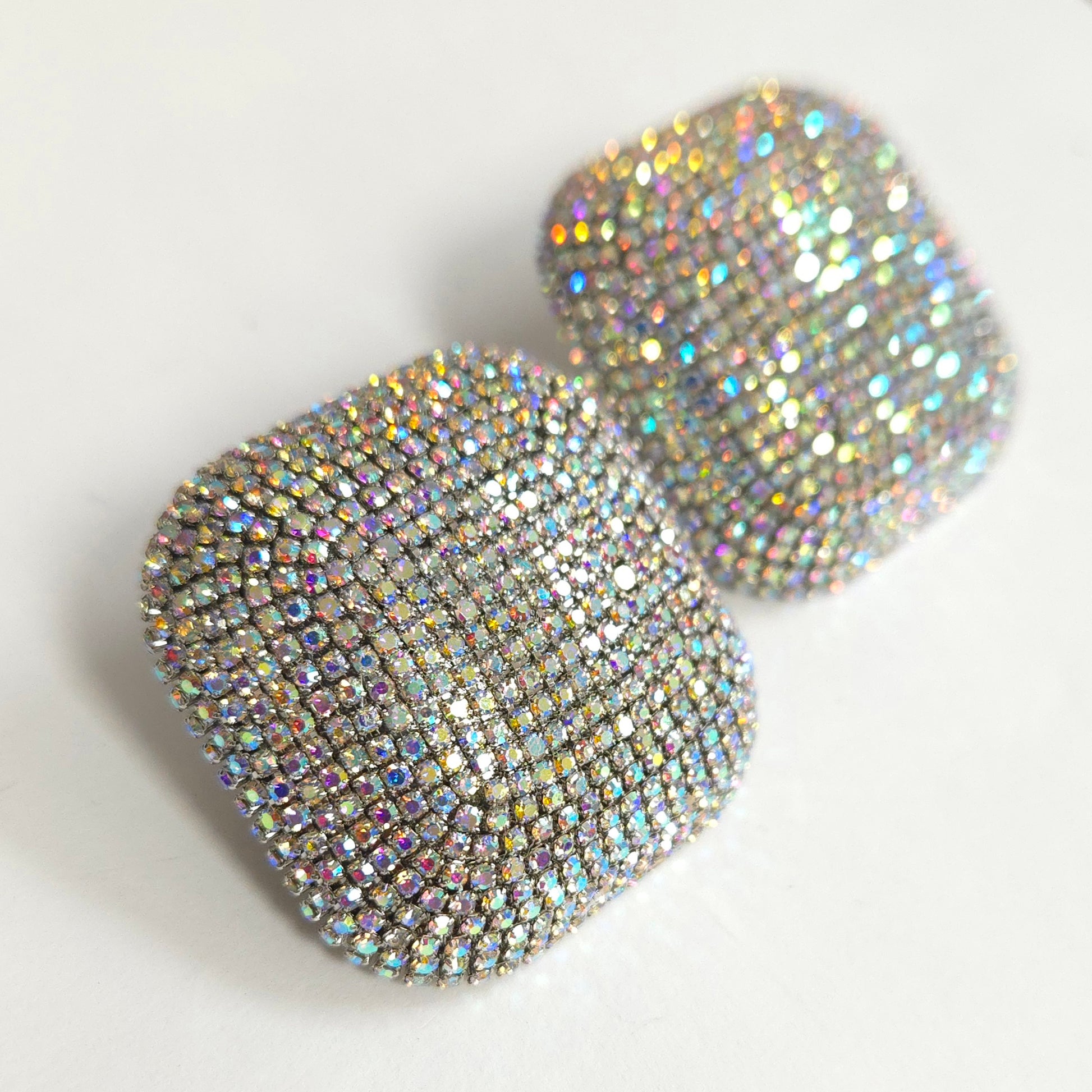 Sparkly heart-shaped earrings on a light background