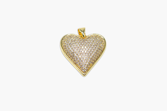 Heart-shaped gold pendant with clear stones on a white background