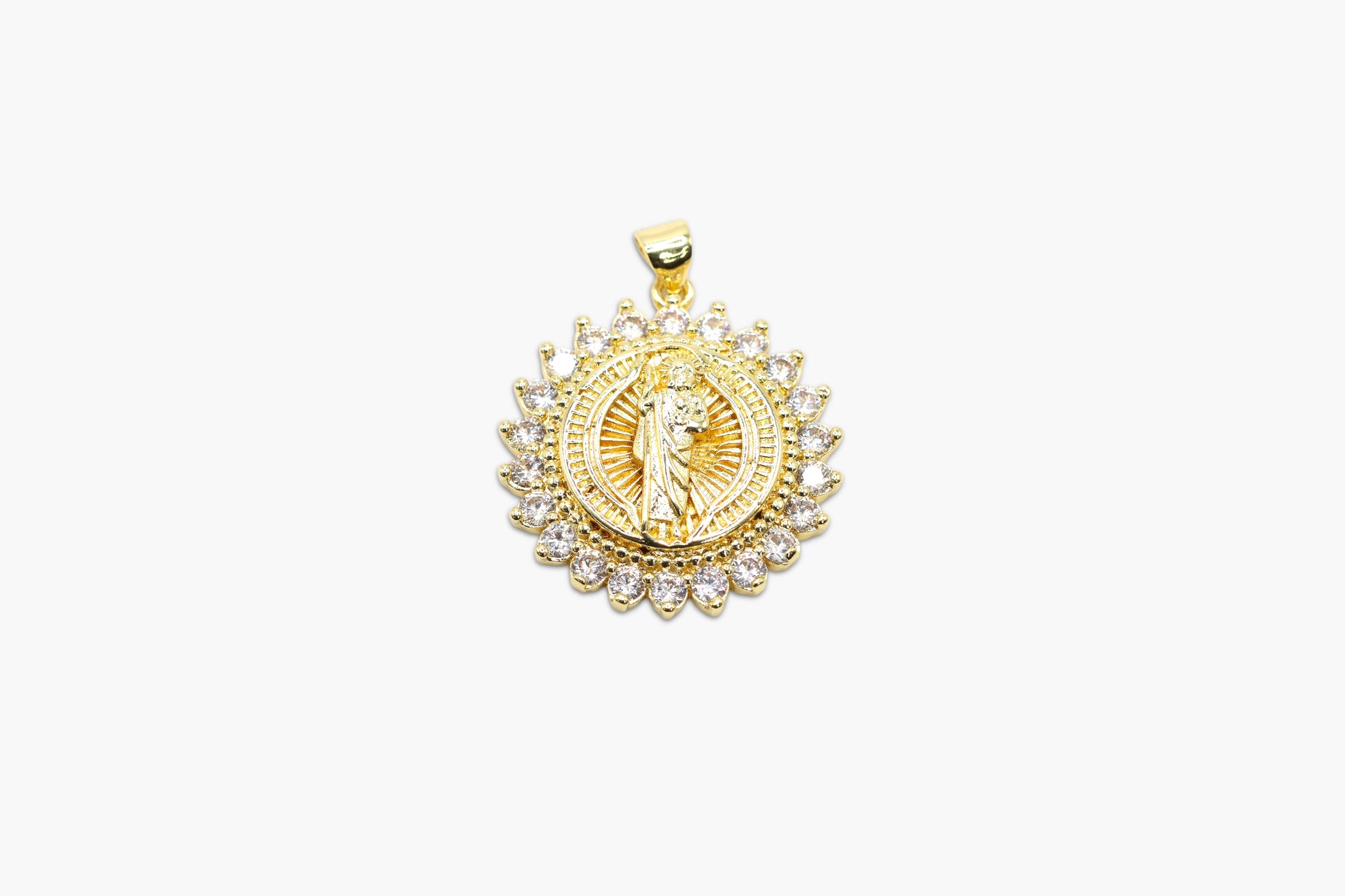 Gold pendant with intricate design on a white background