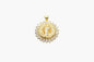 Gold pendant with intricate design on a white background