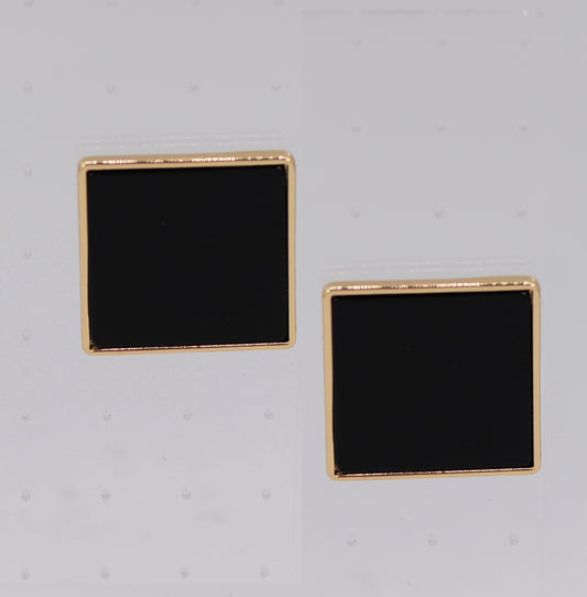 Pair of square black earrings with gold rims on a light gray background