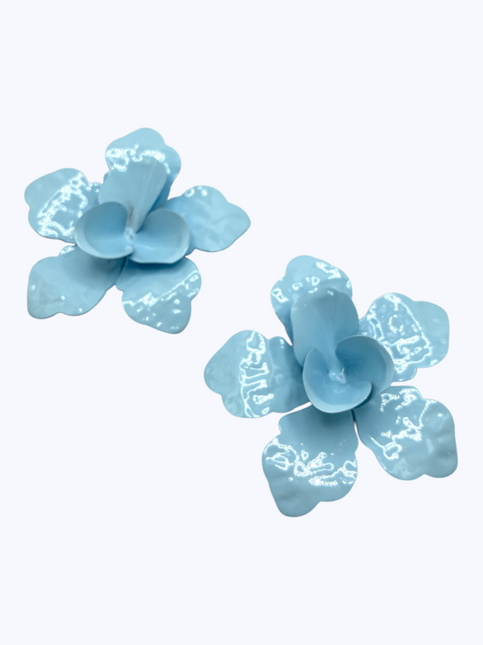 Glossy light blue flower stud earrings with sculpted petal design, playful feminine statement jewelry, lightweight floral fashion accessory.