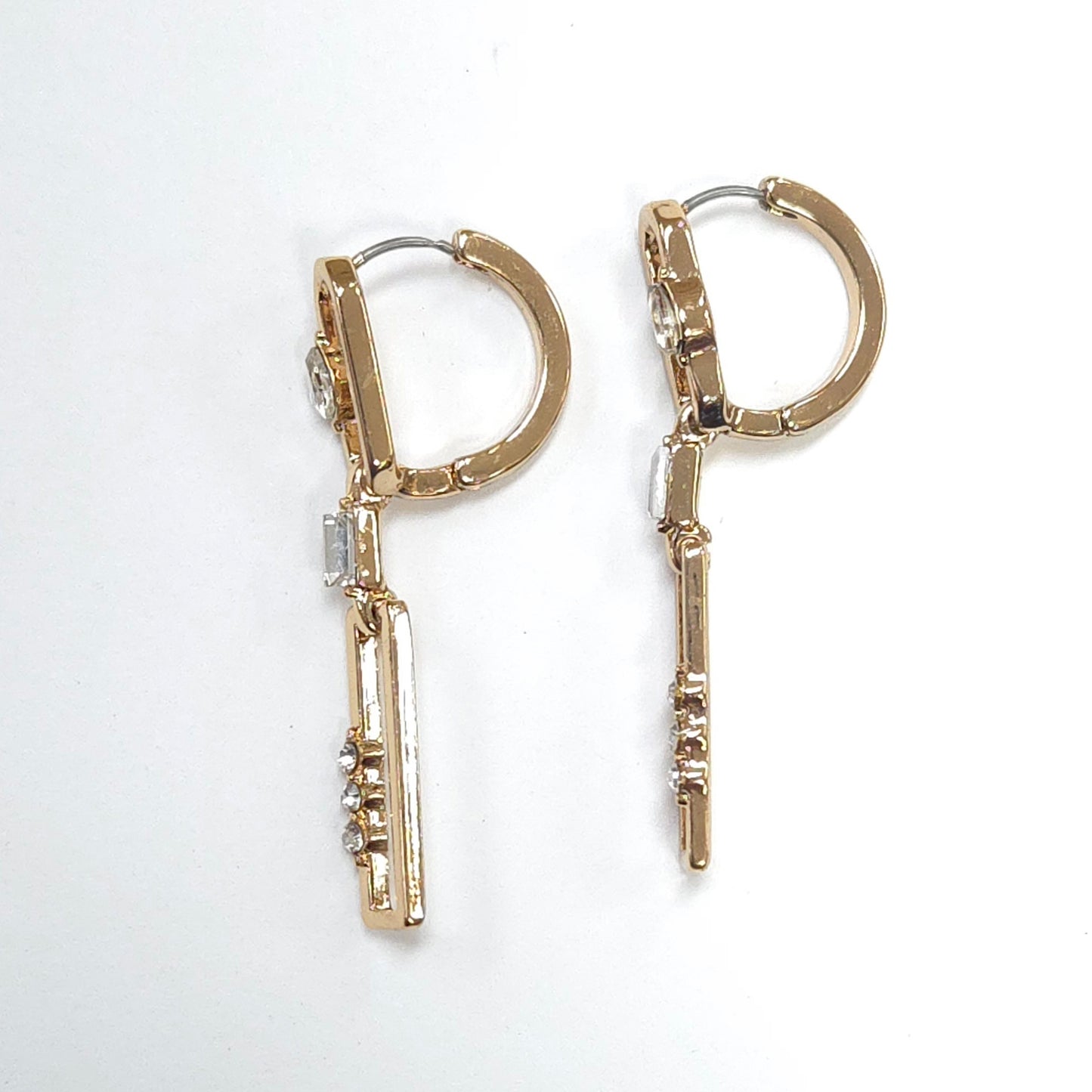 Gold hoop earrings with bar and gemstone designs on a white background
