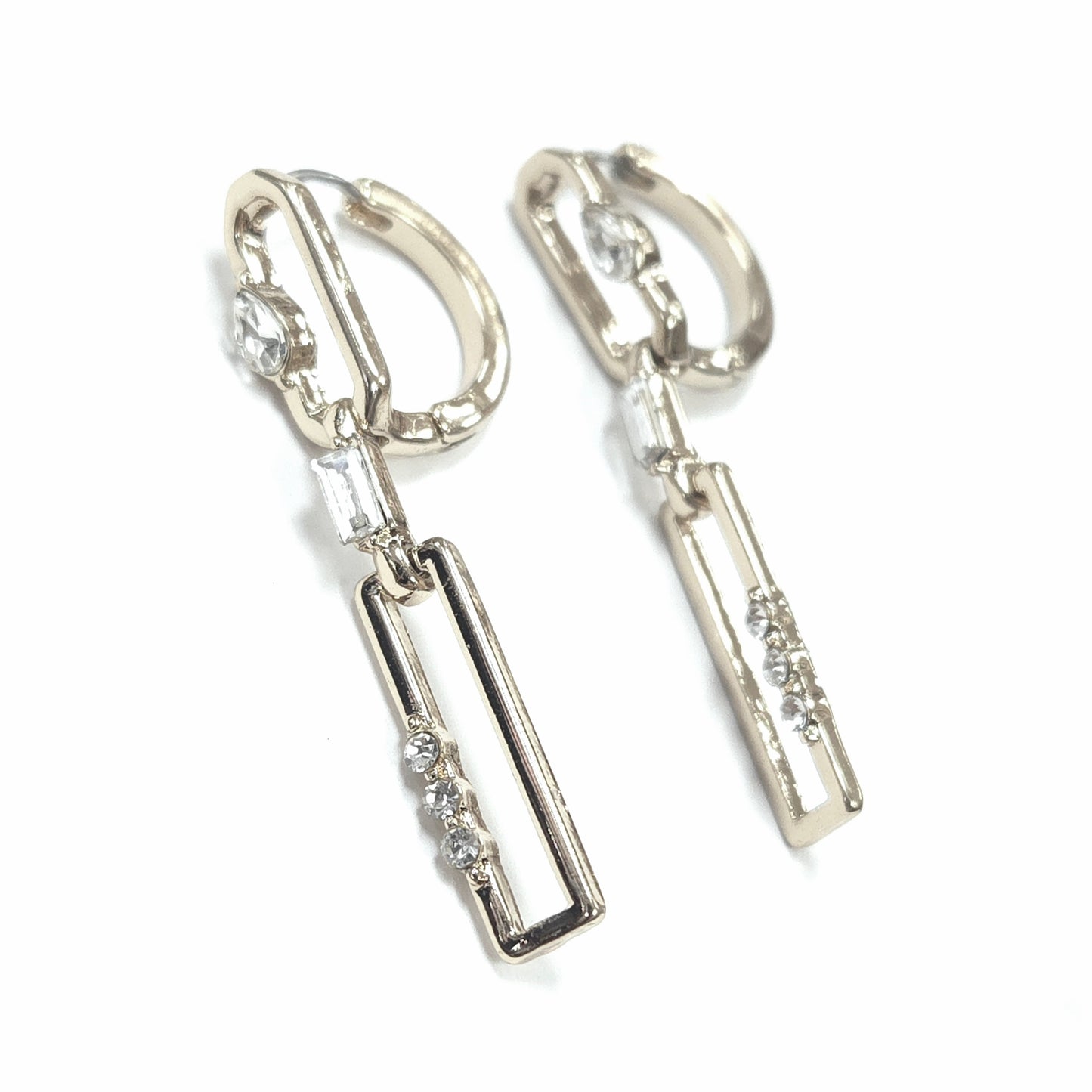 Silver hoop earrings with dangling rectangular pendants on a white background