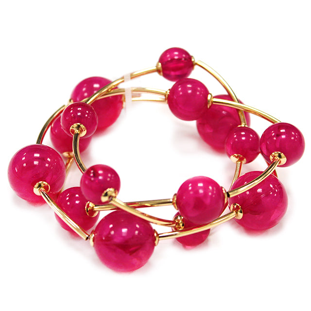 Multi strand acrylic bead coil bracelet with glossy round beads and gold wire accents in fuchsia