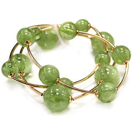 Multi strand acrylic bead coil bracelet with glossy round beads and gold wire accents in green