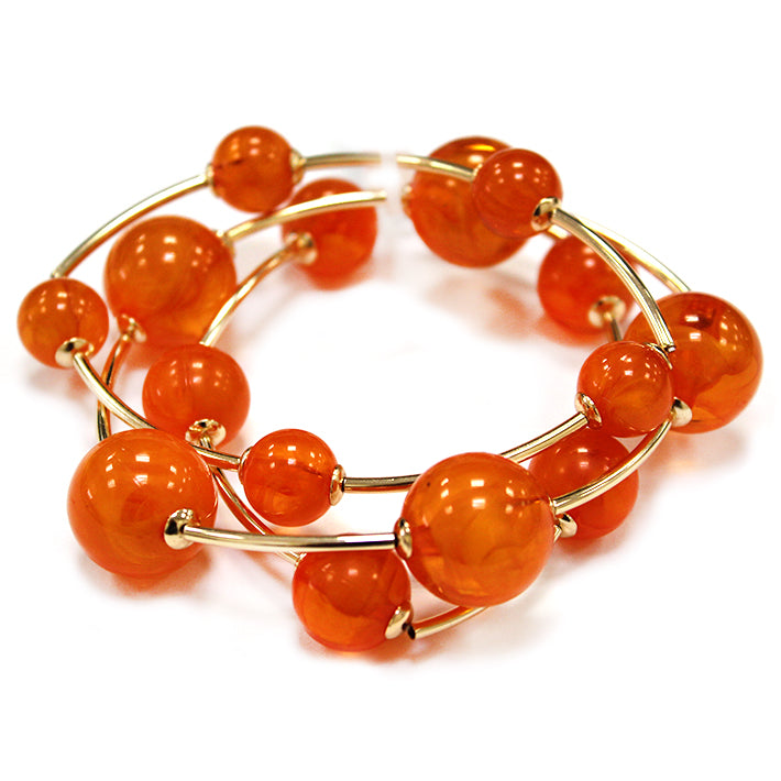 Multi strand acrylic bead coil bracelet with glossy round beads and gold wire accents in orange